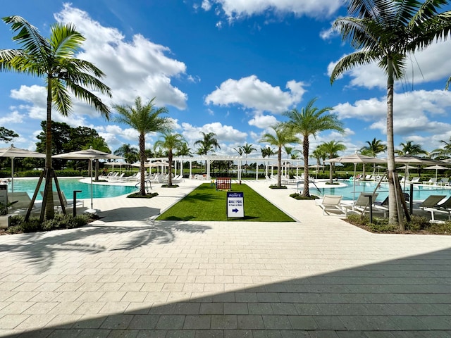 view of swimming pool with a lawn