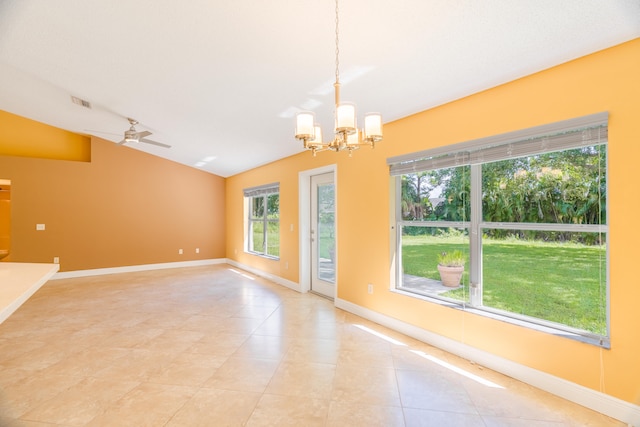 spare room featuring ceiling fan with notable chandelier, vaulted ceiling, and light tile patterned flooring