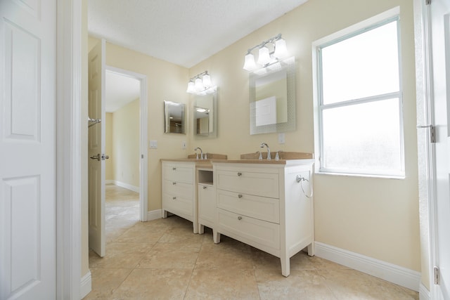 bathroom featuring vanity, a textured ceiling, and tile patterned floors