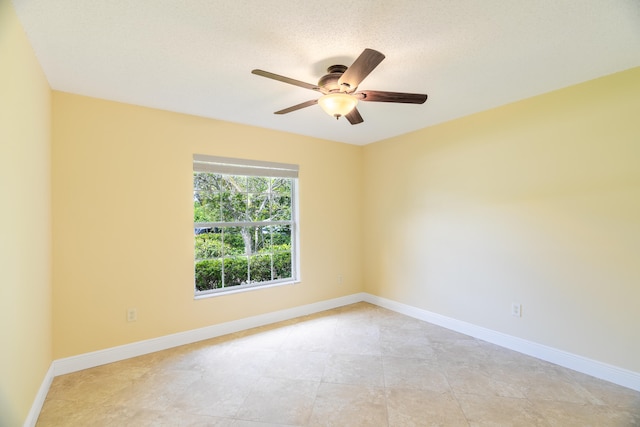 unfurnished room featuring ceiling fan and a textured ceiling