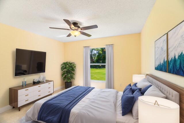 carpeted bedroom featuring ceiling fan and a textured ceiling