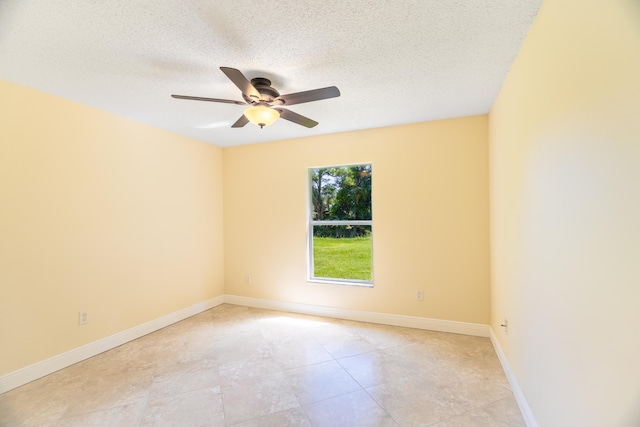 unfurnished room featuring ceiling fan and a textured ceiling