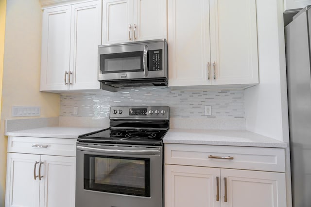 kitchen featuring white cabinetry, appliances with stainless steel finishes, and backsplash