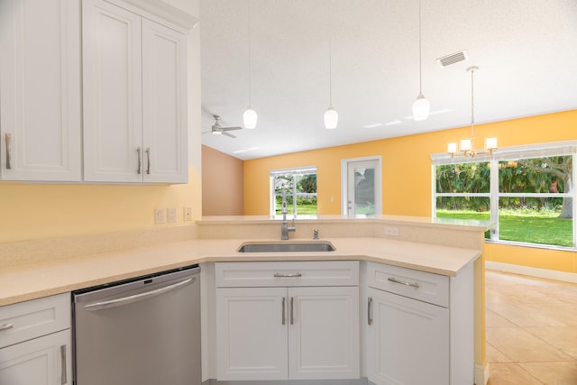 kitchen with hanging light fixtures, white cabinets, ceiling fan with notable chandelier, stainless steel dishwasher, and sink