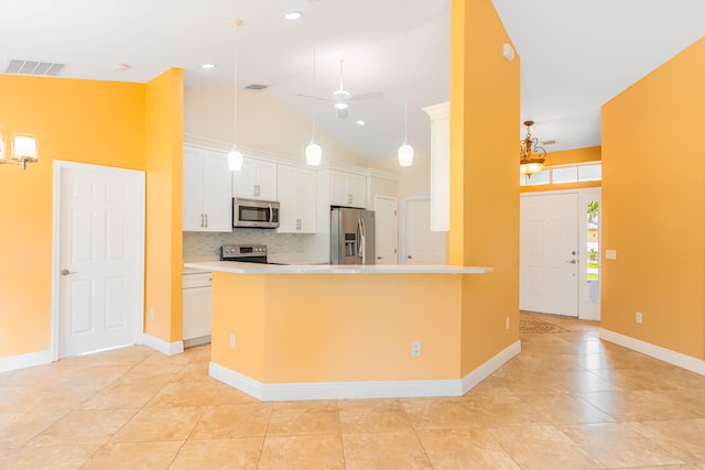 kitchen featuring ceiling fan, white cabinets, appliances with stainless steel finishes, and hanging light fixtures