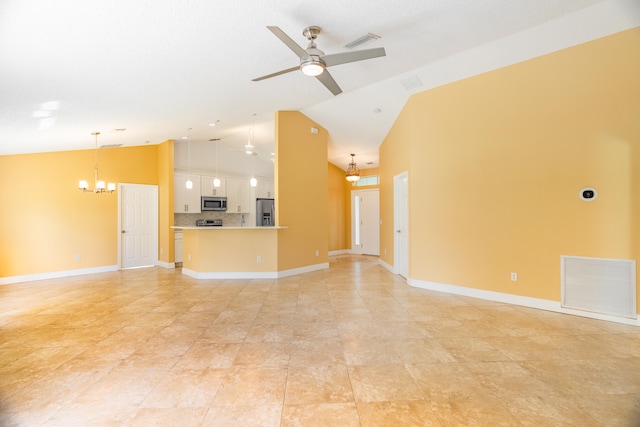 unfurnished living room featuring ceiling fan with notable chandelier and high vaulted ceiling