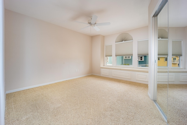 interior space featuring carpet, ceiling fan, and a closet