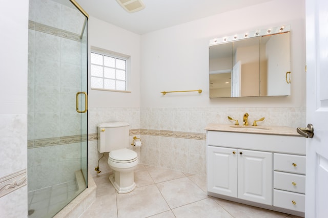 bathroom with tile patterned floors, walk in shower, vanity, tile walls, and toilet