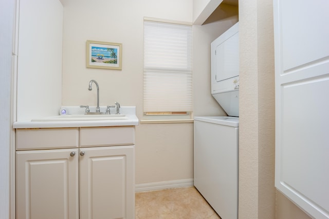 laundry room featuring sink and stacked washer / drying machine