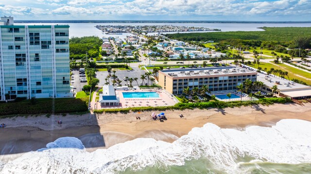 drone / aerial view featuring a view of the beach and a water view