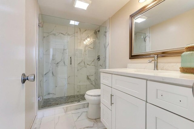 bathroom featuring a shower with door, vanity, and toilet