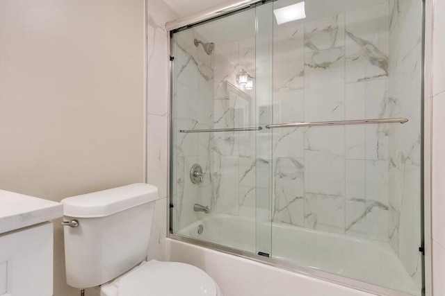 full bathroom featuring shower / bath combination with glass door, vanity, and toilet