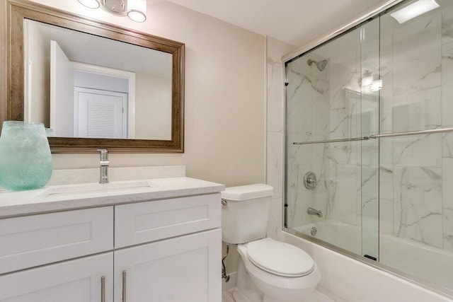 full bathroom with enclosed tub / shower combo, vanity, and toilet