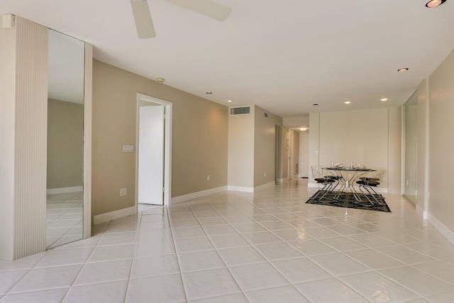 tiled empty room with ceiling fan