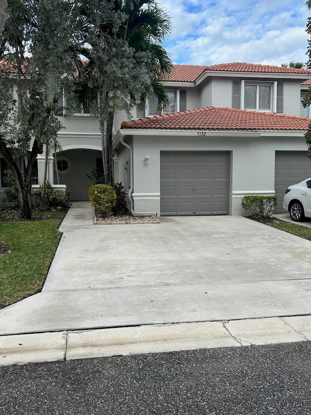 mediterranean / spanish-style house with a garage