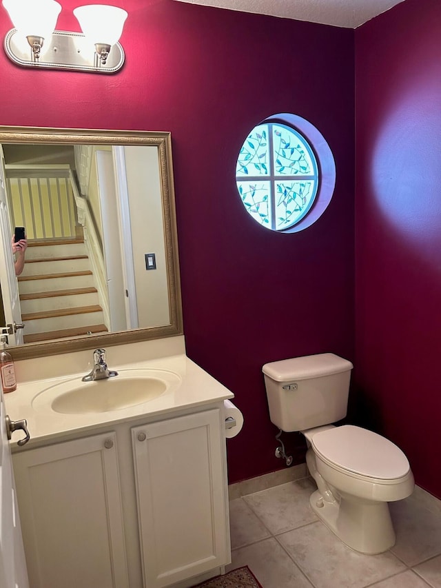 bathroom with tile patterned floors, vanity, and toilet