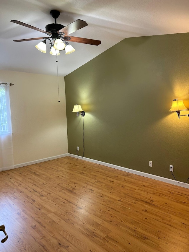 unfurnished room featuring hardwood / wood-style floors, ceiling fan, and lofted ceiling