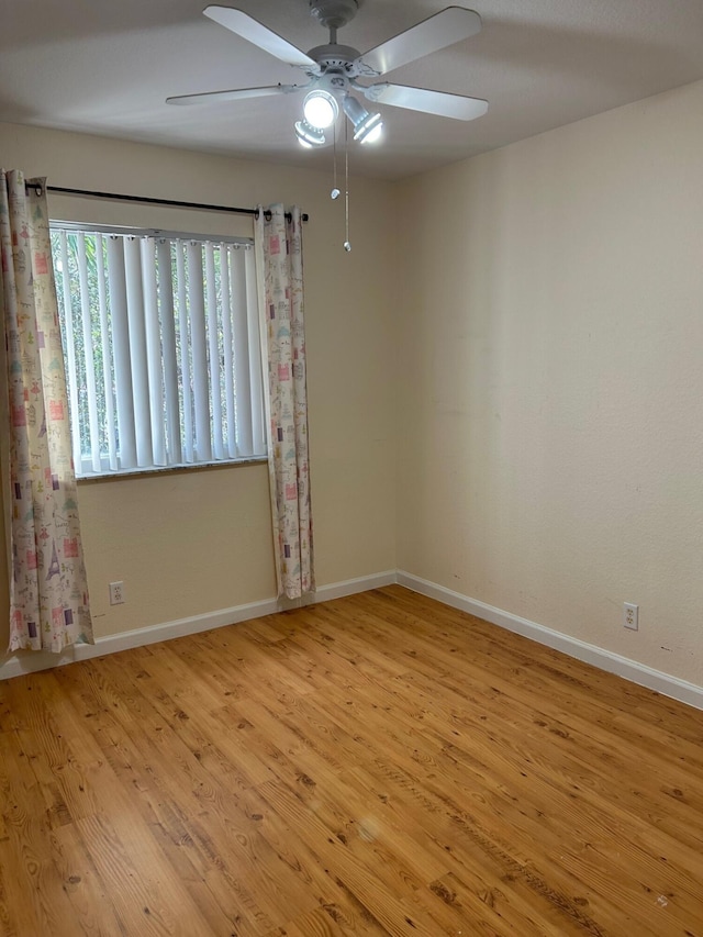 empty room featuring ceiling fan and light hardwood / wood-style flooring