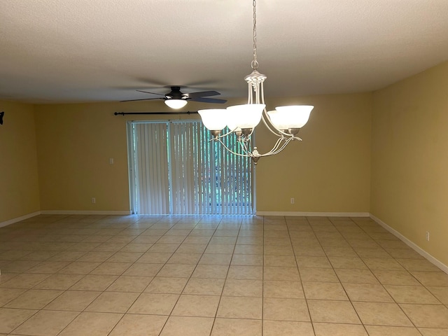 tiled empty room featuring ceiling fan with notable chandelier and a textured ceiling