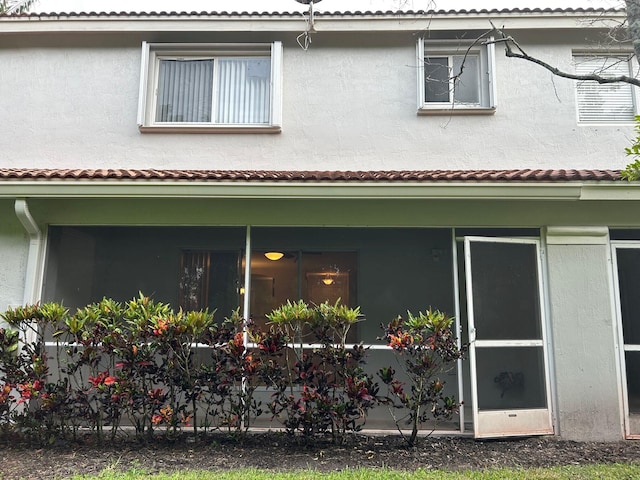 view of home's exterior with a sunroom