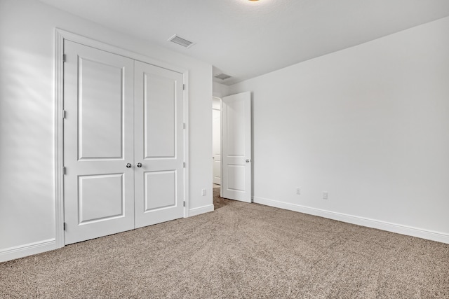 unfurnished bedroom featuring a closet and carpet