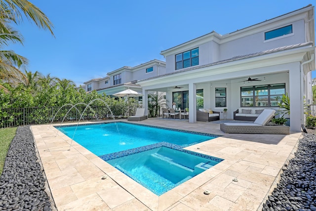 view of swimming pool with ceiling fan, outdoor lounge area, pool water feature, an in ground hot tub, and a patio