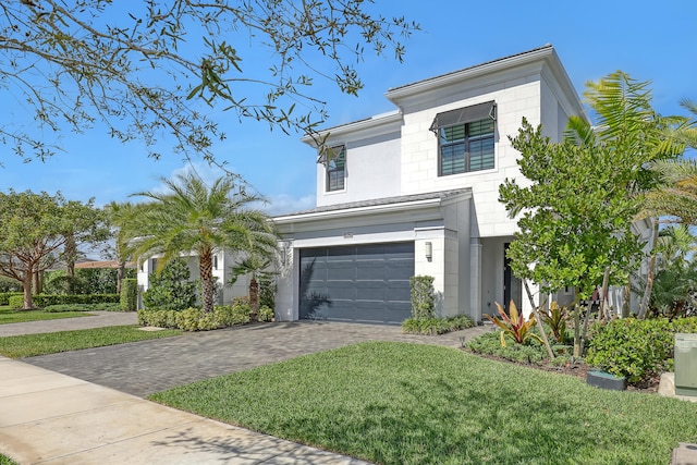 view of front of house with a front lawn and a garage