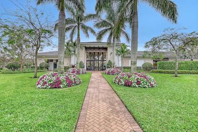 view of front of home featuring a front lawn and french doors