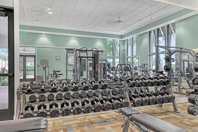 workout area with ceiling fan and a paneled ceiling