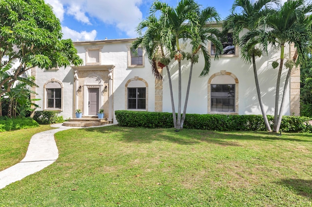 mediterranean / spanish-style home featuring a front lawn