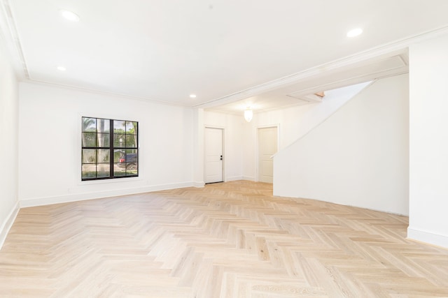 spare room featuring crown molding and light parquet flooring