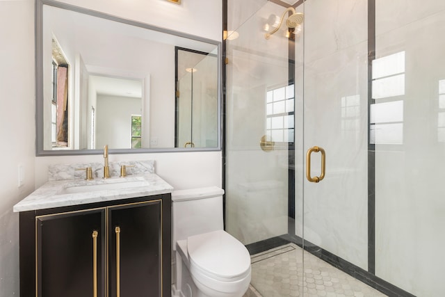 bathroom featuring vanity, toilet, and walk in shower