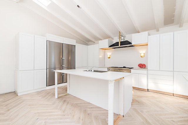 kitchen with sink, white cabinetry, a kitchen island with sink, and appliances with stainless steel finishes