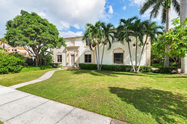 mediterranean / spanish-style home featuring a front yard