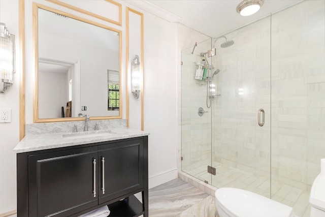 bathroom with vanity, toilet, and an enclosed shower