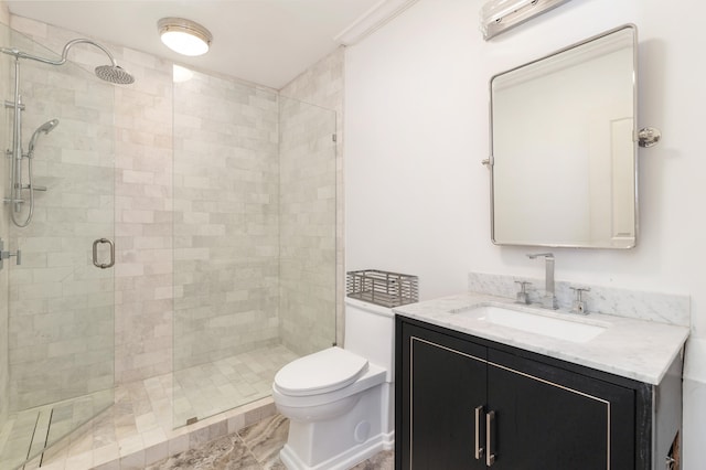 bathroom featuring a shower with door, vanity, ornamental molding, and toilet