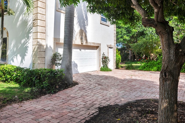 view of side of home featuring a garage