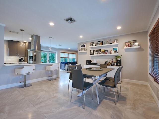 dining room featuring ornamental molding