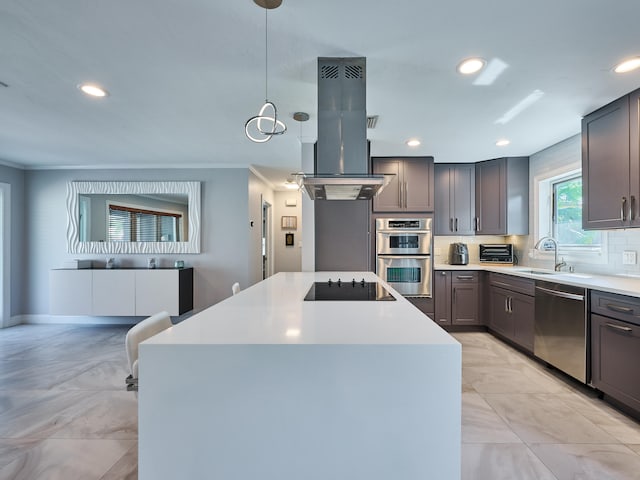 kitchen with a center island, sink, island exhaust hood, pendant lighting, and appliances with stainless steel finishes