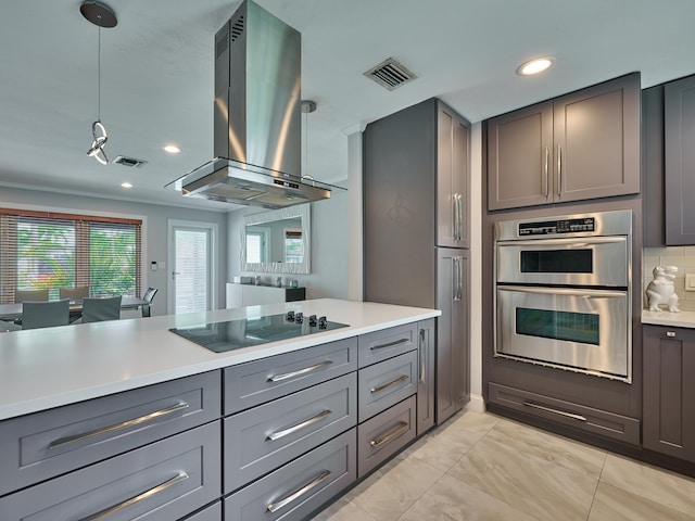 kitchen with black electric cooktop, decorative light fixtures, double oven, island exhaust hood, and gray cabinetry