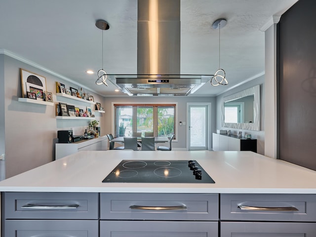 kitchen featuring black electric stovetop, gray cabinetry, wall chimney range hood, ornamental molding, and light countertops