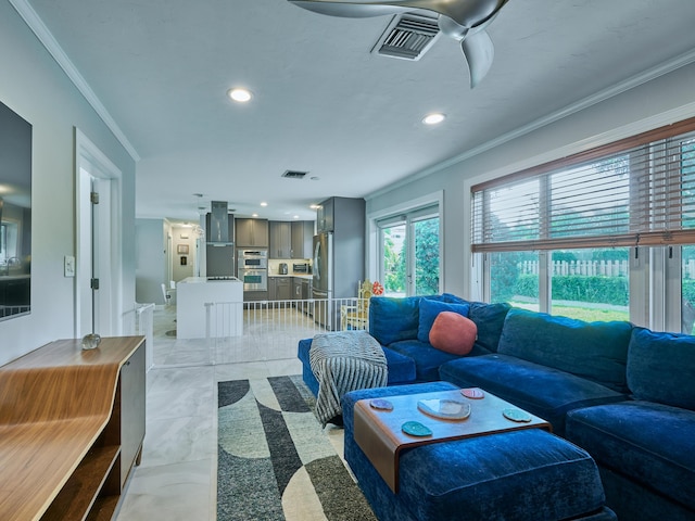 living area with ornamental molding, recessed lighting, and light marble finish flooring
