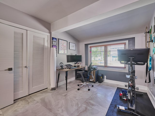 office area featuring baseboards and lofted ceiling
