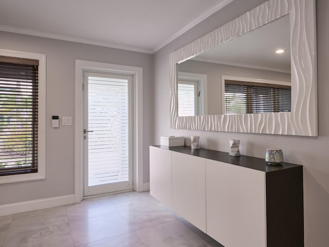 doorway to outside with light tile patterned floors and crown molding