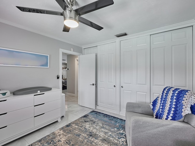 living area featuring crown molding, light marble finish floors, and a ceiling fan