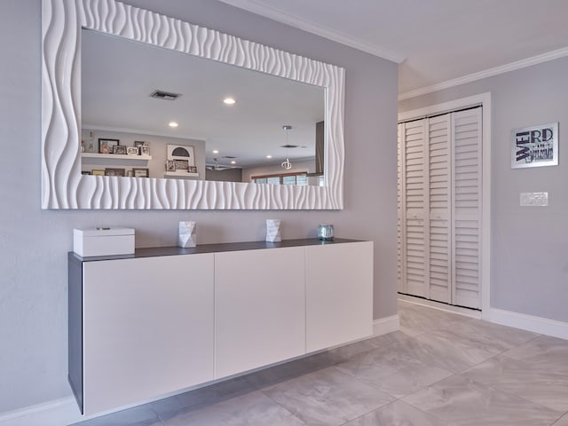 interior space with white cabinets and ornamental molding