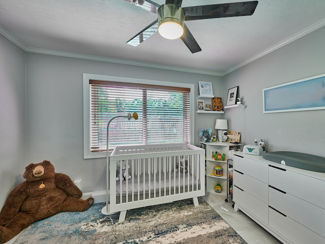 tiled bedroom featuring ceiling fan, crown molding, and a nursery area