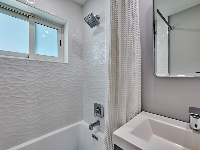 bathroom featuring sink and shower / bathtub combination with curtain