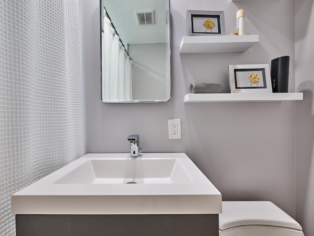 bathroom with vanity and toilet