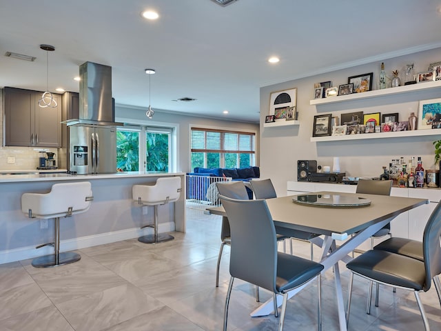 dining room with ornamental molding, recessed lighting, and baseboards